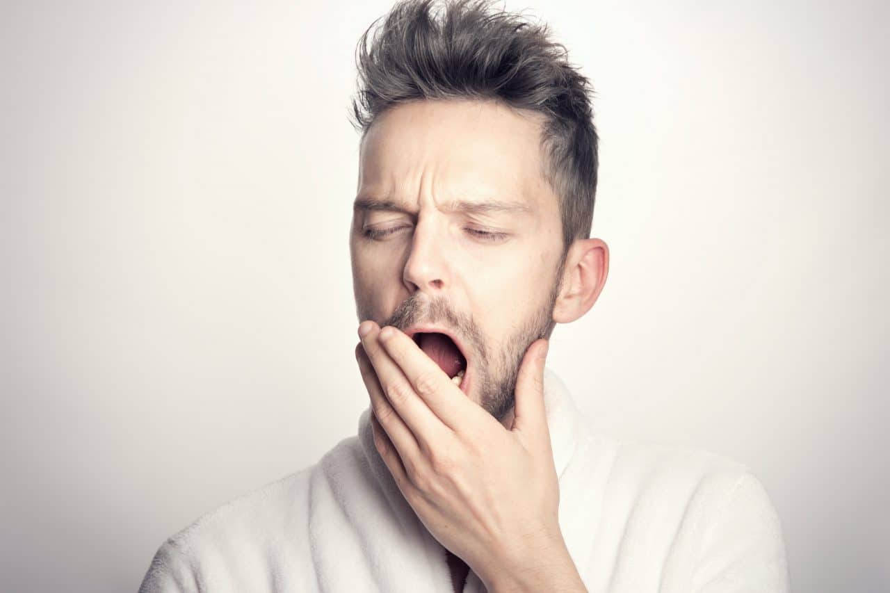 Close up of man yawning.