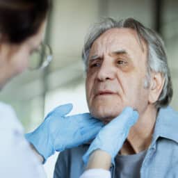 ENT specialist checking a man's throat