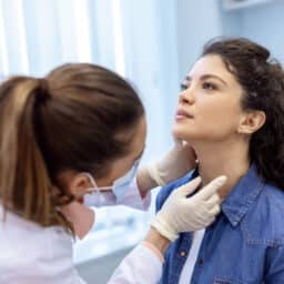 ENT physician conducting a throat exam