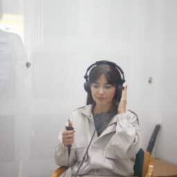 Young woman with headphones on taking a hearing test