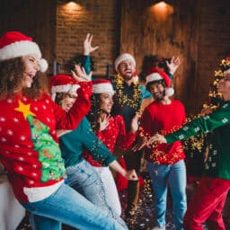 Happy group of friends dancing at a holiday party